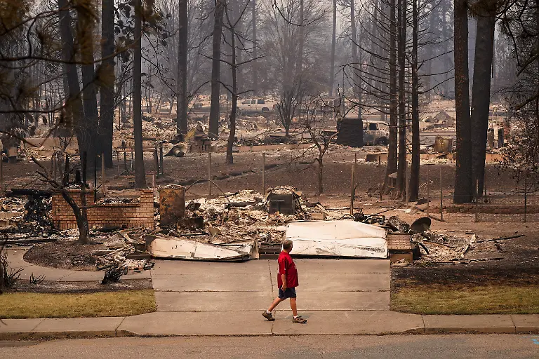 A-man-walks-among-an-incinerated-neighbourhood-in-the-Old-Trails-Fire-in-Spokane-Washington-U-S-August-3-2026