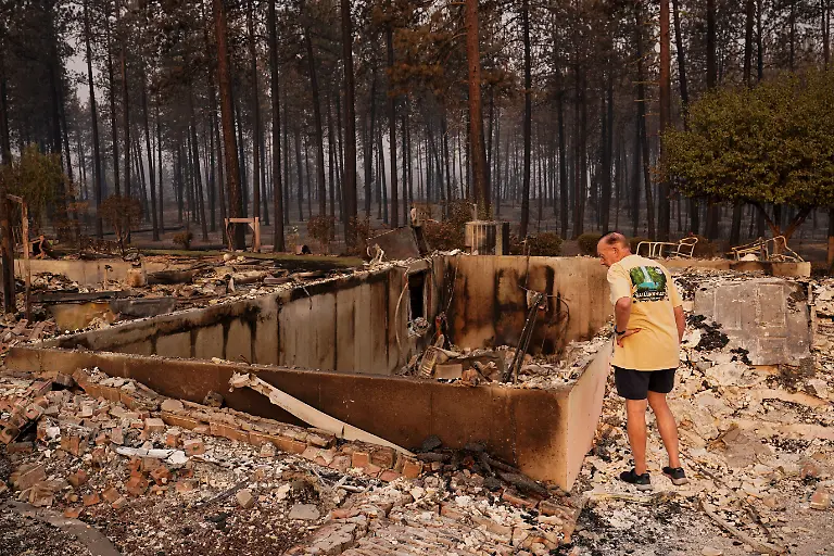 Bruce-Town-surveys-damage-to-a-home-he-built-and-lived-in-for-28-years-before-later-selling-it-in-the-area-burned-by-the-Old-Trails-Fire-wildfire-in-Spokane-Washington-U-S-August-4-2026