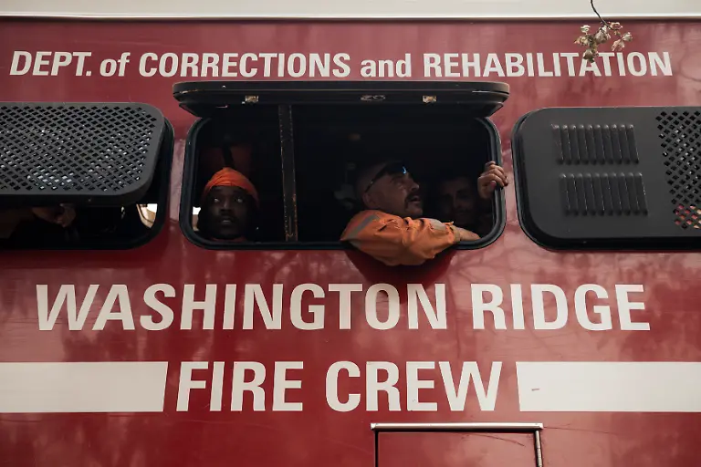 Inmate-firefighters-with-the-California-Department-of-Corrections-and-Rehabilitation-s-Washington-Ridge-Conservation-Camp-look-out-from-their-crew-transport-during-the-Gann-Fire-near-Angels-Camp-in-Calaveras-County-Calif-Tuesday-Aug-4-2026