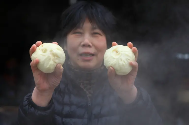 File-A-Baozi-store-staff-shows-Baozi-or-steamed-buns-at-a-Baozi-store-in-Yangzhou-city-east-China-s-Jiangsu-province-12-January-2020