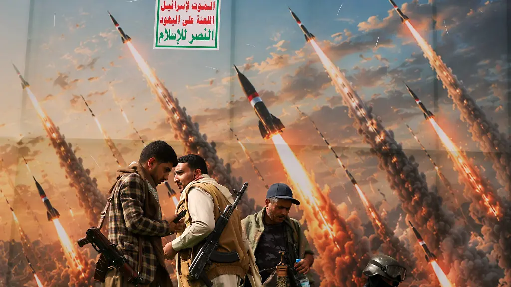 Houthi-activists-stand-on-a-platform-against-a-banner-depicting-Houthi-missiles-at-an-anti-Saudi-rally-amid-an-escalation-with-the-kingdom-in-Sanaa-Yemen-July-31-2026