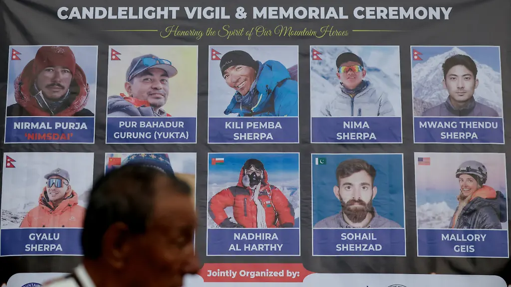 A-man-stands-in-front-of-the-portraits-of-climbers-who-lost-their-life-in-an-avalanche-while-summiting-Broad-Peak-in-Pakistan-during-a-vigil-to-honour-climbers-including-celebrated-British-Nepali-climber-Nirmal-Purja-also-known-as-Nimsdai-in-Kathmandu-Nepal-August-4-2026