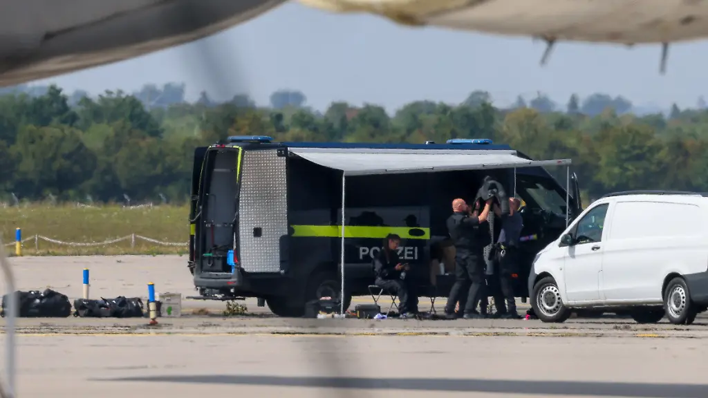 Police-officers-work-in-the-vicinity-of-an-Antonov-cargo-plane-near-which-a-drone-was-found-at-Leipzig-Halle-Airport-in-Schkeuditz-Germany-August-5-2026-after-the-police-said-explosives-experts-examined-a-drone-near-a-runway-and-after-a-DHL-cargo-aircraft-hit-an-unknown-object-as-it-was-climbing-away-from-the-airport-overnight-prompting-an-unscheduled-landing-in-Hanover-according-to-a-source-familiar-with-the-incident