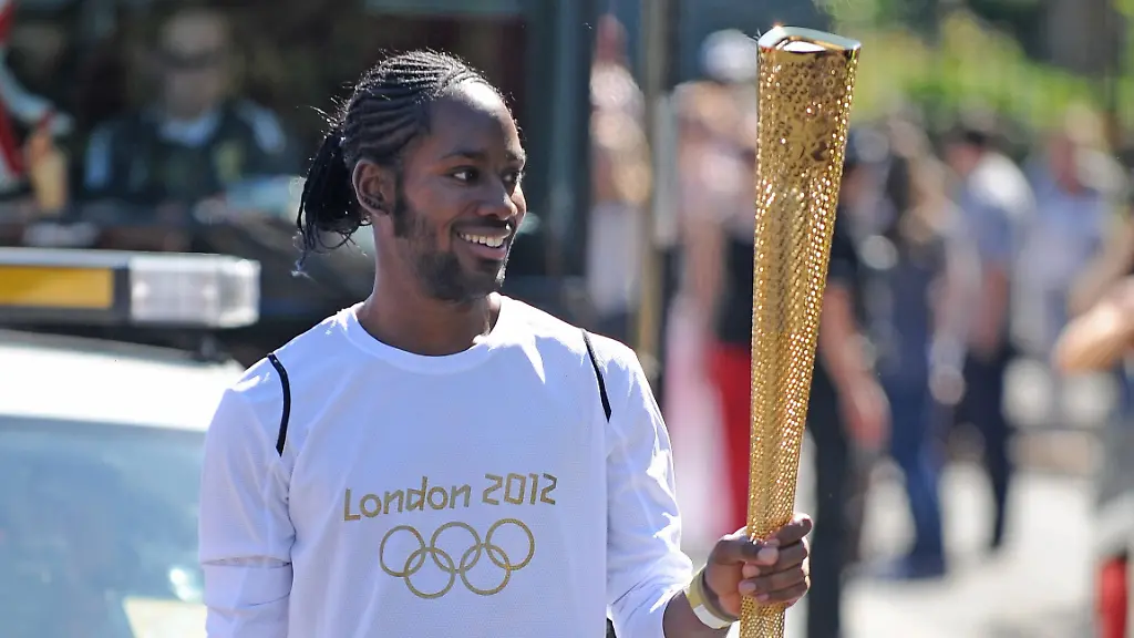 Jason-Arday-resignation-File-photo-dated-23-7-12-of-Torchbearer-132-Jason-Arday-carries-the-Olympic-Flame-on-the-Torch-Relay-leg-between-Sutton-London-Borough-and-Merton-London-Borough-Professor-Jason-Arday-a-professor-of-sociology-of-education-who-became-Cambridge-s-youngest-black-professor-in-2023-resigned-from-his-post-on-Wednesday-evening-after-the-university-launched-an-inquiry-into-his-academic-qualifications-and-honorary-appointments-Issue-date-Thursday-August-6-2026