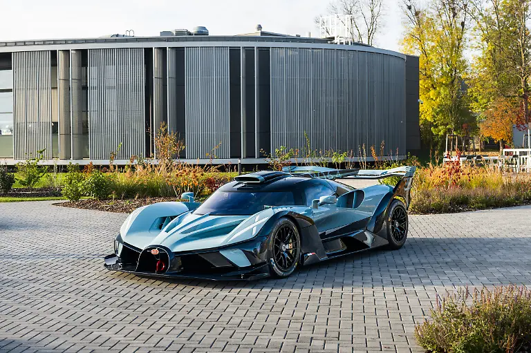 Bugatti-has-unveiled-its-final-Bolide-hypercar-the-last-to-use-its-super-powerful-8-litre-W16-engine-The-W16-made-its-debut-in-the-Bugatti-Veyron-in-2005-a-car-that-became-famous-for-its-incredible-speed-Thhat-car-had-a-top-speed-of-407-km-h-253-mph-It-was-named-the-2000s-Car-of-the-Decade-by-the-BBC-television-programme-Top-Gear-whose-races-featuring-the-car-made-it-a-motoring-icon-First-dreamt-up-in-2021-as-the-latest-in-Bugatti-s-line-of-hypercars-the-Bolides-design-work-was-finalised-in-2022-with-engineering-completed-in-early-2023-Thousands-of-hours-of-analysis-refinement-and-testing-resulted-in-the-first-prototypes-which-took-to-the-track-soon-after-Le-Mans-2023-became-a-defining-moment-for-the-project-At-the-circuits-centenary-celebrations-Bugatti-Pilote-Officiel-Andy-Wallace-pushed-the-Bolide-to-350km-h-on-the-straight-the-car-wearing-a-special-livery-honouring-Bugattis-racing-triumphs-of-the-1930s-Only-40-have-ever-been-made-The-final-one-was-commissioned-by-a-longtime-Bugatti-collector-and-draws-inspiration-from-the-owners-cherished-Type-35-Its-bespoke-colour-scheme-featuring-Black-Blue-Special-Blue-Lyonnais-and-Lake-Blue-Alcantara-echoes-the-vibrant-racing-blues-that-have-defined-Bugattis-competition-heritage-for-generations-The-customer-also-specified-the-same-palette-for-his-Veyron-Grand-Sport-the-final-example-of-that-model-creating-what-Bugatti-describes-as-a-trilogy-spanning-decades-Details-such-as-the-French-flag-on-the-flanks-and-Light-Blue-Sport-interior-stitching-further-celebrate-the-marques-racing-lineage-and-the-owners-personal-connection-to-the-brand-When-the-customer-arrived-at-Bugattis-Molsheim-HQ-to-take-delivery-the-handover-was-marked-with-an-intimate-celebration-reflecting-what-Bugatti-calls-the-family-spirit-that-binds-the-marque-to-its-most-dedicated-clients