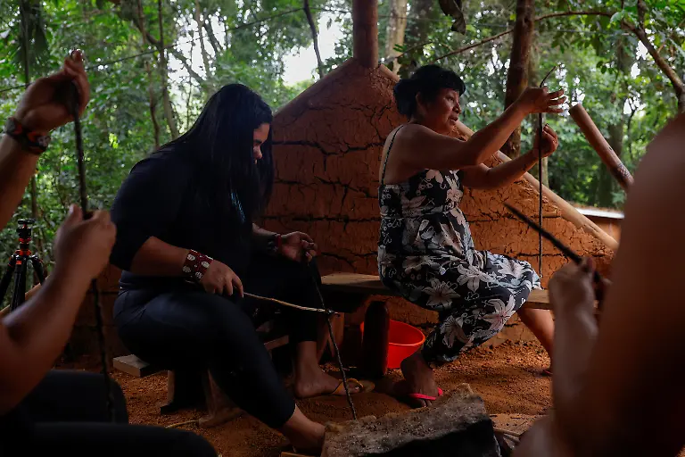 Irene-Mendonca-Marcio-Karai-s-mother-and-other-Guarani-Indigenous-women-make-handmade-candles-by-melting-native-beeswax-collected-locally-and-applying-it-to-pieces-of-fabric-a-tradition-passed-down-through-generations-as-they-prepare-for-the-Nhemongarai-a-baptism-ritual-in-the-Jaragua-Indigenous-Territory-in-Sao-Paulo-Brazil-January-13-2024-The-candles-are-made-by-Guarani-women-Karai-says-explaining-that-the-spiritual-world-is-strengthened-through-feminine-spirituality-REUTERS-Amanda-Perobelli-SEARCH-PEROBELLI-BRAZIL-BEES-FOR-THIS-STORY-SEARCH-WIDER-IMAGE-FOR-ALL-STORIES