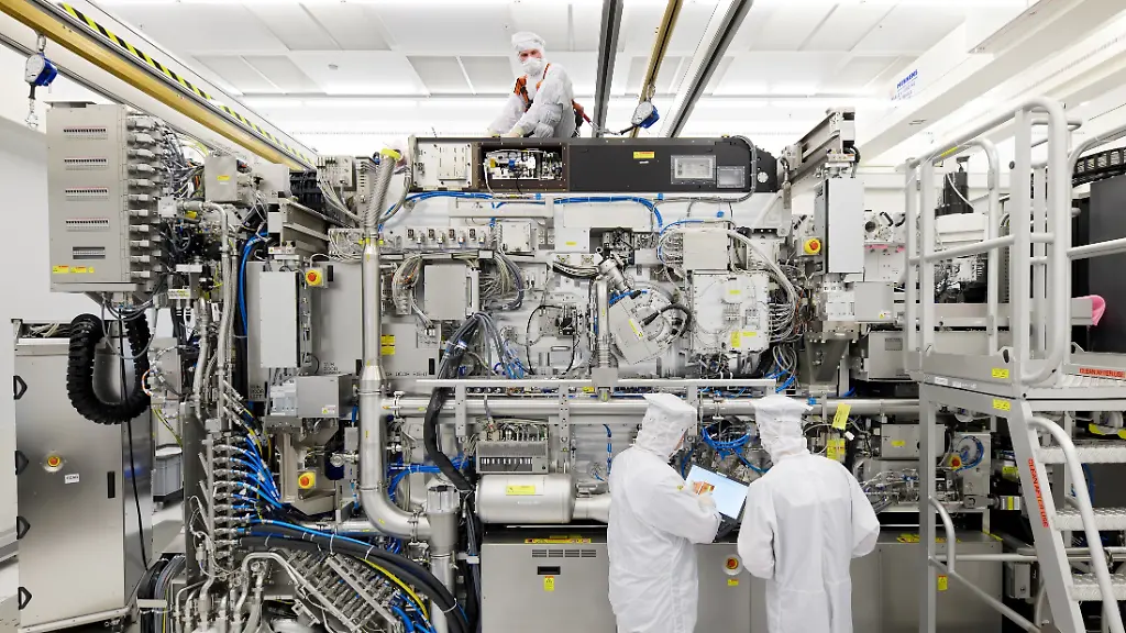 Employees-are-seen-working-on-the-final-assembly-of-ASML-s-TWINSCAN-NXE-3400B-semiconductor-lithography-tool-with-its-panels-removed-in-Veldhoven-Netherlands-in-this-picture-taken-April-4-2019-Bart-van-Overbeeke-Fotografie-ASML-Handout-via-REUTERS-ATTENTION-EDITORS-THIS-IMAGE-HAS-BEEN-SUPPLIED-BY-A-THIRD-PARTY-MANDATORY-CREDIT