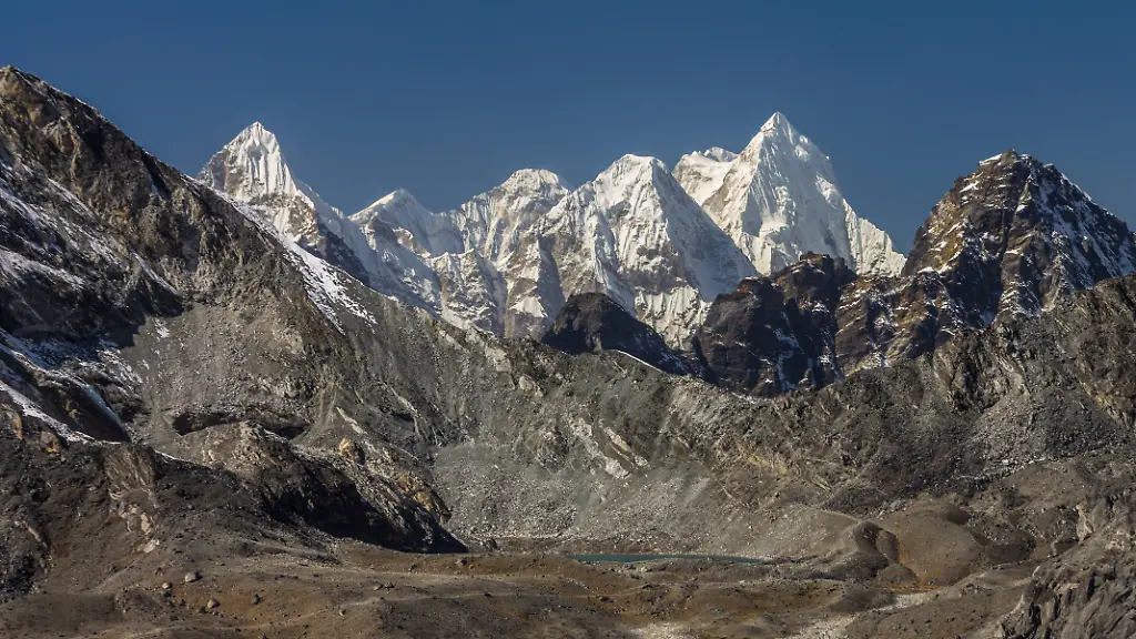 A-long-distance-view-from-Chukhung-Ri-Peaks-of-Rolwaling-Himal-View-towards-West-from-Chukhung-Ri-5550m-a-trekking-peak-in-the-Imja-Khola-Valley-There-is-Kongma-La-the-lowest-point-on-the-ridge-above-the-visible-lake-Left-of-it-the-ridge-rises-towards-Pokalde-another-peak-available-to-trekkers-Behind-the-pass-far-distant-peaks-of-Rolwaling-Himal-are-seen-including-Dragnag-Ri-Gaurishankar-and-Malungtse-Sagarmatha-National-Park-Everest-Region-Nepal-Copyright-xZoonar