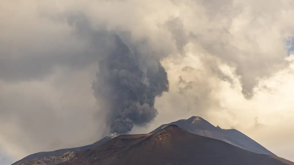 Mount-Etna-erupts-sending-ash-plume-over-Catania-Sicily-CATANIA-ITALY-JULY-30-Mount-Etna-spews-a-column-of-ash-after-over-three-weeks-of-apparent-calm-on-July-30-2026-in-Catania-Sicily-Italy-The-activity-which-began-at-approximately-3-30-AM-local-time-was-characterized-by-intense-Strombolian-activity-which-evolved-into-a-lava-fountain-during-the-morning-Massive-ash-emission-from-the-Voragine-summit-crater-generated-an-eruption-column-that-reached-approximately-7-kilometers-above-sea-level-dispersing-west-and-northwest-with-ashfall-reported-in-the-town-of-Bronte