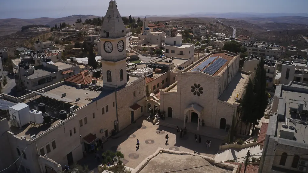 Palestinian-parishioners-stand-outside-Christ-the-Redeemer-Church-after-attending-a-morning-Mass-in-the-West-Bank-village-of-Taybeh-Sept-28-2025