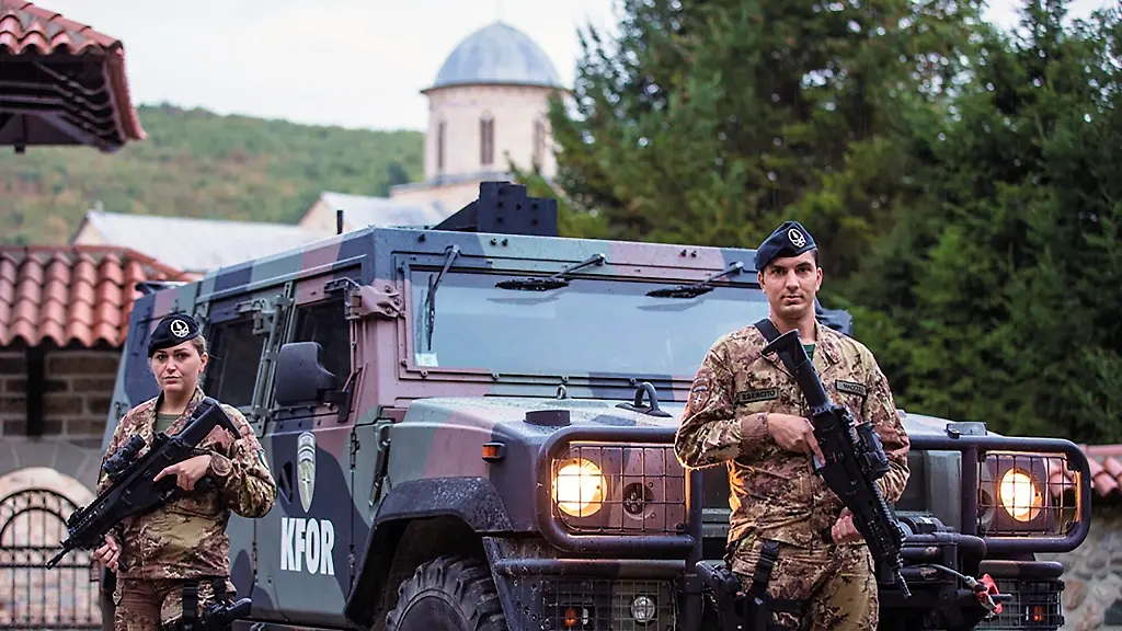 In-this-Oct-14-2020-photo-provided-by-the-NATO-led-peacekeepers-KFOR-press-office-KFOR-soldiers-guard-the-14th-Century-Visoki-Decani-Monastery-Italian-mediation-on-Thursday-Nov-12-2020-helped-resolve-a-long-running-dispute-between-Kosovo-s-ethnic-Albanian-government-and-the-Serb-minority-allowing-a-highway-project-that-will-bypass-the-historic-Christian-Orthodox-monastery-listed-as-an-endangered-World-Heritage-site
