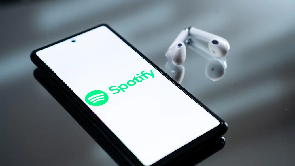 The-Spotify-logo-appears-on-a-smartphone-screen-next-to-wireless-earbuds-in-this-illustration-photo-taken-in-Athens-Greece-on-February-17-2026