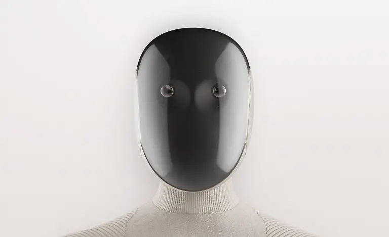 VIDEO-AVAILABLE-CONTACT-INFO-COVERMG-COM-TO-RECEIVE-A-humanoid-A-I-powered-home-help-robot-is-set-to-be-tested-in-homes-Norway-and-Silicon-Valley-based-robotics-firm-1X-has-unveiled-its-latest-humanoid-robot-Neo-Gamma-It-is-designed-to-assist-with-household-chores-while-blending-seamlessly-into-domestic-settings-Wrapped-in-a-beige-3D-knitted-bodysuit-the-robot-aims-to-fit-into-homes-with-its-minimalist-appearance-Neo-Gamma-boasts-a-more-Scandinavian-inspired-design-and-is-equipped-to-perform-tasks-such-as-vacuuming-tidying-and-doing-the-laundry-The-robots-integrated-artificial-intelligence-system-enables-it-to-approximate-human-speech-and-body-language-enhancing-its-ability-to-interact-with-users-Neo-Gamma-s-humanoid-frame-includes-advanced-audio-and-communication-features-It-has-four-microphones-for-audio-capture-and-a-speaker-system-with-one-speaker-in-the-chest-for-AI-voice-interaction-and-two-in-the-pelvis-for-bass-sound-effects-and-music-To-improve-communication-1X-has-added-emotive-ear-rings-on-the-sides-of-the-robot-s-head-which-light-up-to-indicate-when-it-is-speaking-or-listening-The-robot-has-been-trained-using-human-motion-capture-data-allowing-it-to-walk-with-a-natural-gait-swing-its-arms-squat-and-sit-in-chairs-Images-released-by-1X-show-Neo-Gamma-performing-everyday-household-tasks-such-as-preparing-coffee-and-vacuuming-floors-Its-multi-jointed-hands-which-mimic-human-tendon-movement-are-controlled-by-elastic-motors-and-encased-in-soft-covers-for-additional-safety-While-the-Neo-Gamma-is-still-a-prototype-the-company-plans-to-begin-limited-in-home-testing-The-soft-knitted-nylon-covering-serves-both-aesthetic-and-practical-purposes-It-reduces-potential-injuries-from-robot-to-human-contact-and-helps-lower-the-robot-s-operating-noise-to-about-the-same-level-as-a-refrigerator-according-to-1X-A-significant-factor-in-Neo-Gammas-advanced-capabilities-lies-in-the-firms-partnership-with-OpenAI