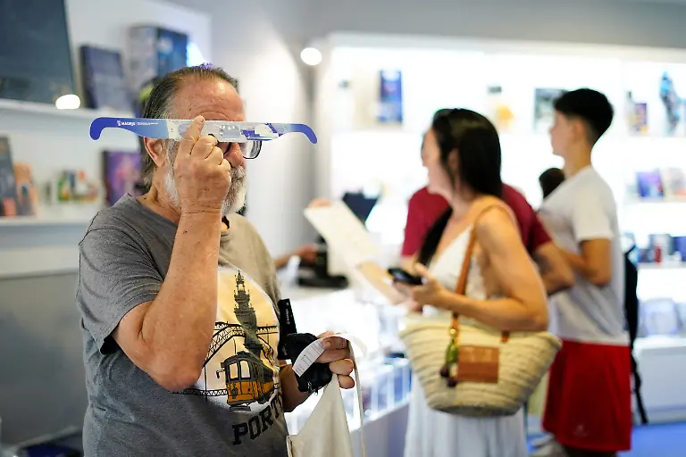 A-person-tries-eclipse-viewing-glasses-in-Madrid-s-Planetarium-store-as-the-city-counts-down-to-the-solar-eclipse-on-August-12-in-Madrid-Spain-August-9-2026