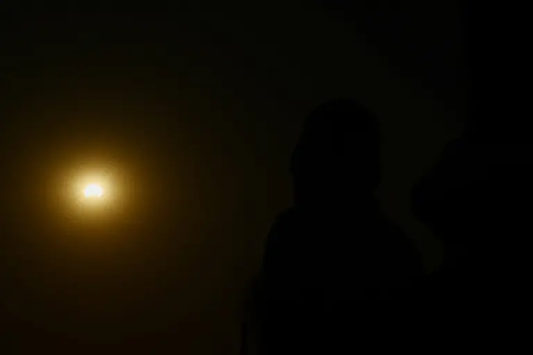 A-person-looks-at-the-sun-on-the-day-of-a-solar-eclipse-as-seen-from-Paris-France-August-12-2026