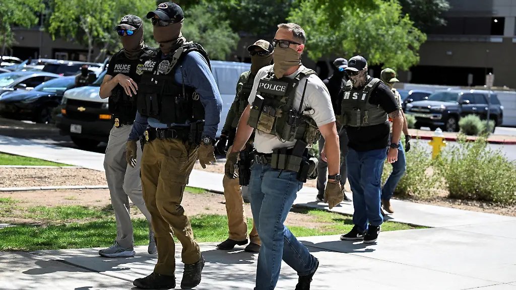 FILE-PHOTO-Masked-law-enforcement-officers-including-HSI-and-ICE-agents-walk-into-an-immigration-court-in-Phoenix-Arizona-U-S-May-21-2025
