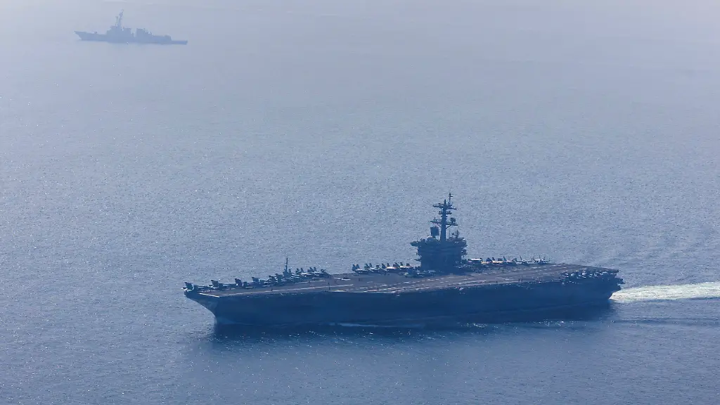 The-U-S-Navy-s-Nimitz-class-aircraft-carrier-USS-Abraham-Lincoln-and-Arleigh-Burke-class-guided-missile-destroyer-USS-Frank-E-Petersen-Jr-sail-during-a-photo-exercise-in-the-Arabian-Sea-February-6-2026-U-S