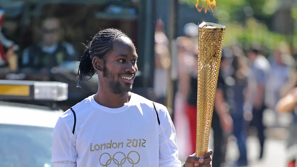 Jason-Arday-resignation-File-photo-dated-23-7-12-of-Torchbearer-132-Jason-Arday-carries-the-Olympic-Flame-on-the-Torch-Relay-leg-between-Sutton-London-Borough-and-Merton-London-Borough-Professor-Jason-Arday-a-professor-of-sociology-of-education-who-became-Cambridge-s-youngest-black-professor-in-2023-resigned-from-his-post-on-Wednesday-evening-after-the-university-launched-an-inquiry-into-his-academic-qualifications-and-honorary-appointments-Issue-date-Thursday-August-6-2026