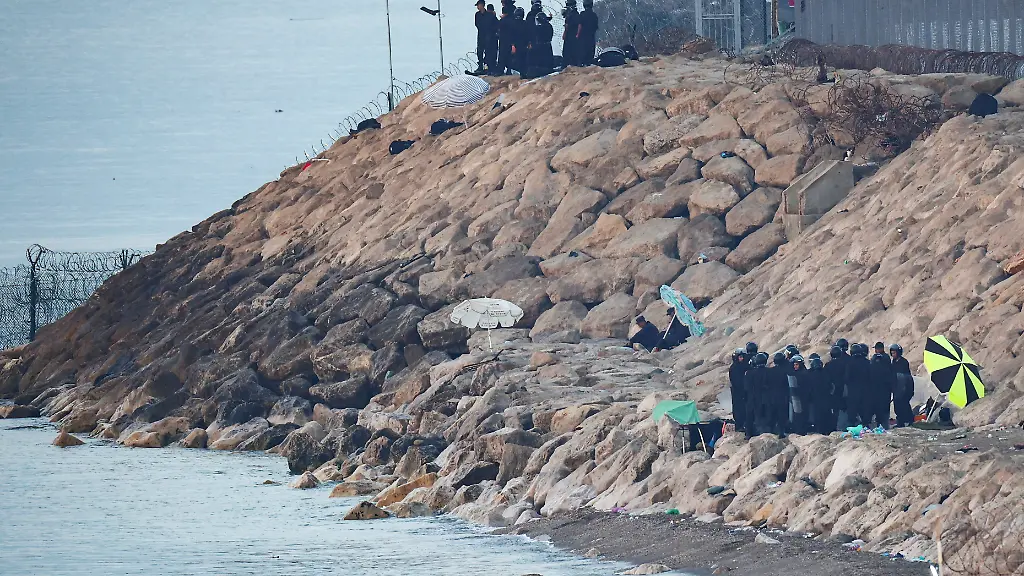 Moroccan-security-personnel-secure-the-beach-on-the-border-with-Spain-in-Ceuta-following-mass-crossings-of-migrants-on-foot-and-by-sea-from-Morocco-into-Spanish-territory-as-seen-from-Ceuta-Spain-August-15-2026
