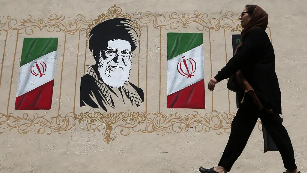 TEHRAN-IRAN-AUGUST-6-RESTRICTIONS-NO-Access-Israel-Media-Persian-Language-TV-Stations-Outside-Iran-Strictly-No-Access-BBC-Persian-VOA-Persian-Manoto-TV-Iran-International-TV-A-woman-walks-in-front-of-a-wall-mural-as-daily-life-continues-amid-ongoing-tensions-between-the-United-States-in-Tehran-Iran-on-August-6-2026-The-tensions-persist-after-U-S-President-Donald-Trump-said-he-preferred-reaching-an-agreement-with-Iran-but-warned-that-the-use-of-force-is-still-an-option-if-diplomacy-fails-Despite-an-agreement-reached-between-Iran-and-the-United-States-through-Pakistani-mediation-on-June-14-the-two-sides-engaged-in-intense-clashes-around-the-Strait-of-Hormuz-beginning-on-July-8-with-the-fighting-lasting-for-nearly-two-weeks