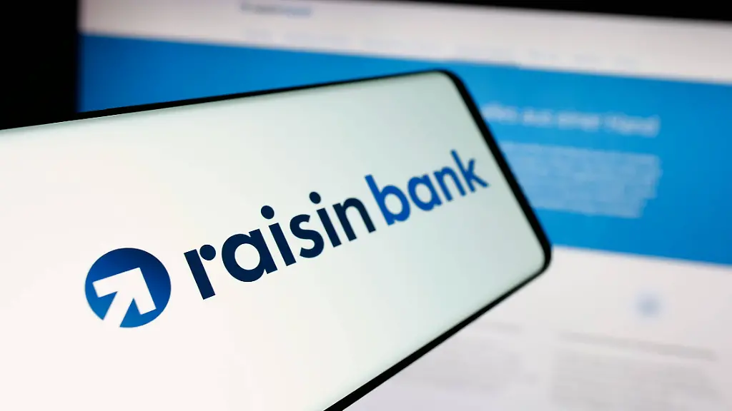 Illustrative-editorial-images-in-Germany-20-Mar-2025-In-this-photo-illustration-a-smartphone-with-the-logo-of-German-financial-company-Raisin-Bank-AG-is-seen-on-screen-in-front-of-website