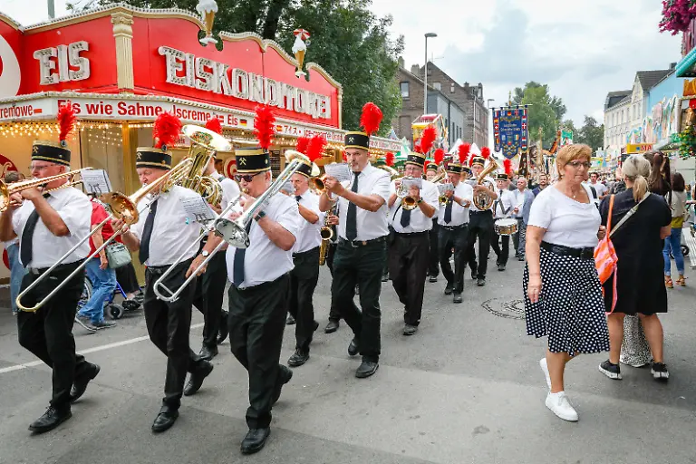Herne-Germany-07th-Aug-2026-Karl-Josef-Laumann-State-Minister-of-Labor-Health-and-Social-Affairs-is-this-year-s-guest-of-honor-and-tours-the-funfair-with-the-Coal-Miner-s-brass-orchester-prior-to-the-opening-event-The-Cranger-Kirmes-funfair-is-Germany-s-largest-family-funfair-and-2nd-larges-overall-after-the-Munich-Octoberfest-with-c-500-rides-and-stalls-and-around-4-Million-visitors-over-10-days-It-has-a-longstanding-tradition-reaching-back-to-a-15th-ct-festive-market-and-horse-fair-in-the-same-spot