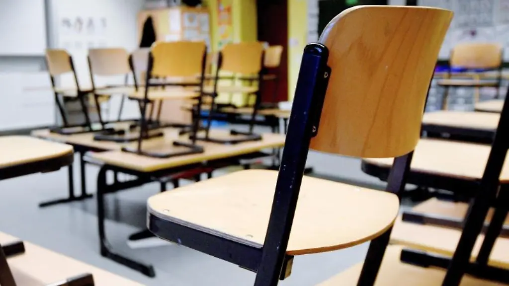 Stuehle-stehen-in-einem-Klassenzimmer-auf-den-Tischen