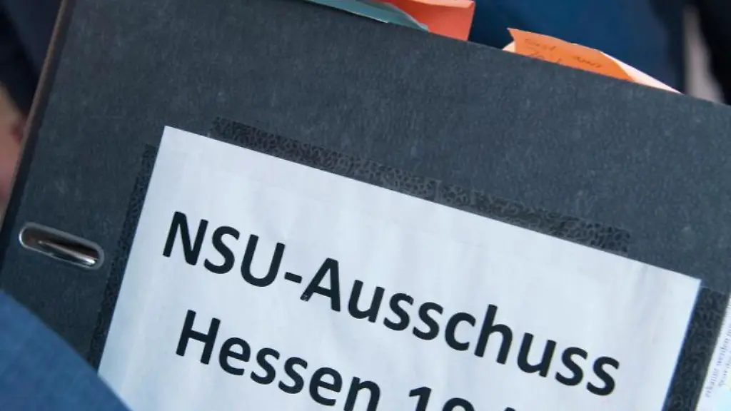 Ein-Mitglied-des-U-Ausschusses-traegt-eine-Kladde-mit-der-Aufschrift-NSU-Ausschuss-Hessen