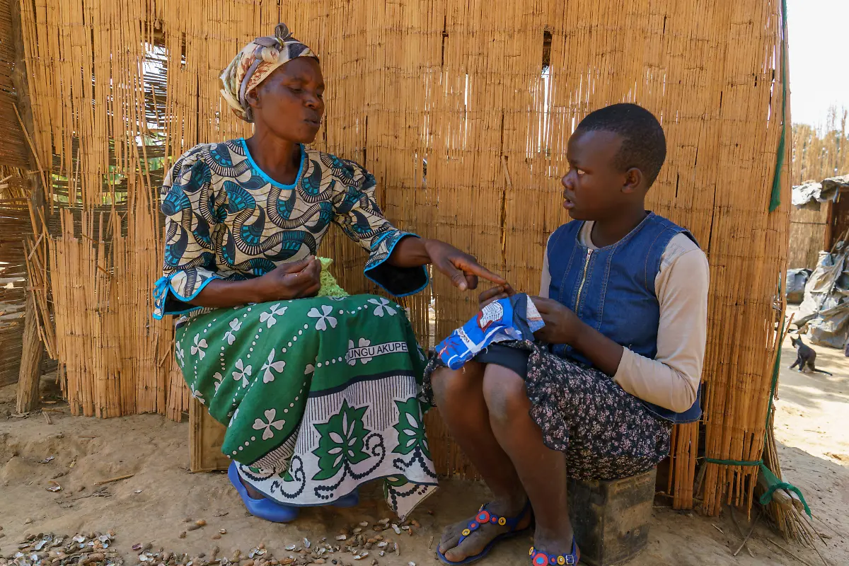 Elizerbeth-54-teaching-her-grand-daughter-Mary-how-to-make-a-sanitary-cloth-locally-known-as-nyanda-in-Kapyanga-Kasungu-Malawi-August-2018