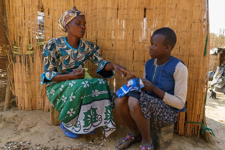 Elizerbeth-54-teaching-her-grand-daughter-Mary-how-to-make-a-sanitary-cloth-locally-known-as-nyanda-in-Kapyanga-Kasungu-Malawi-August-2018