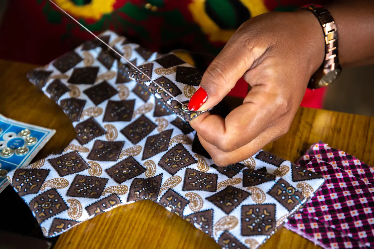 Sangita-32-sewing-a-button-onto-the-reusable-pad-Ready-made-pads-are-costly-and-if-you-do-not-dispose-of-them-properly-it-will-pollute-the-environment-Banepa-Municipality-Kavre-District-Nepal-August-2018