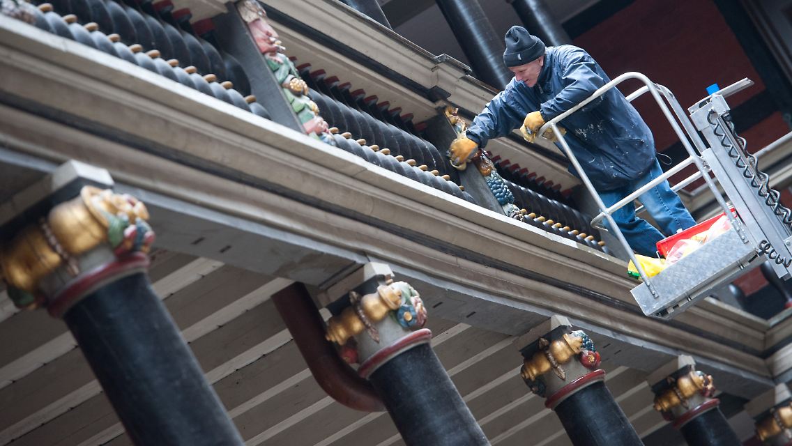 Ein Mitarbeiter der Stadt Stralsund putzt den prächtigen Säulengang.