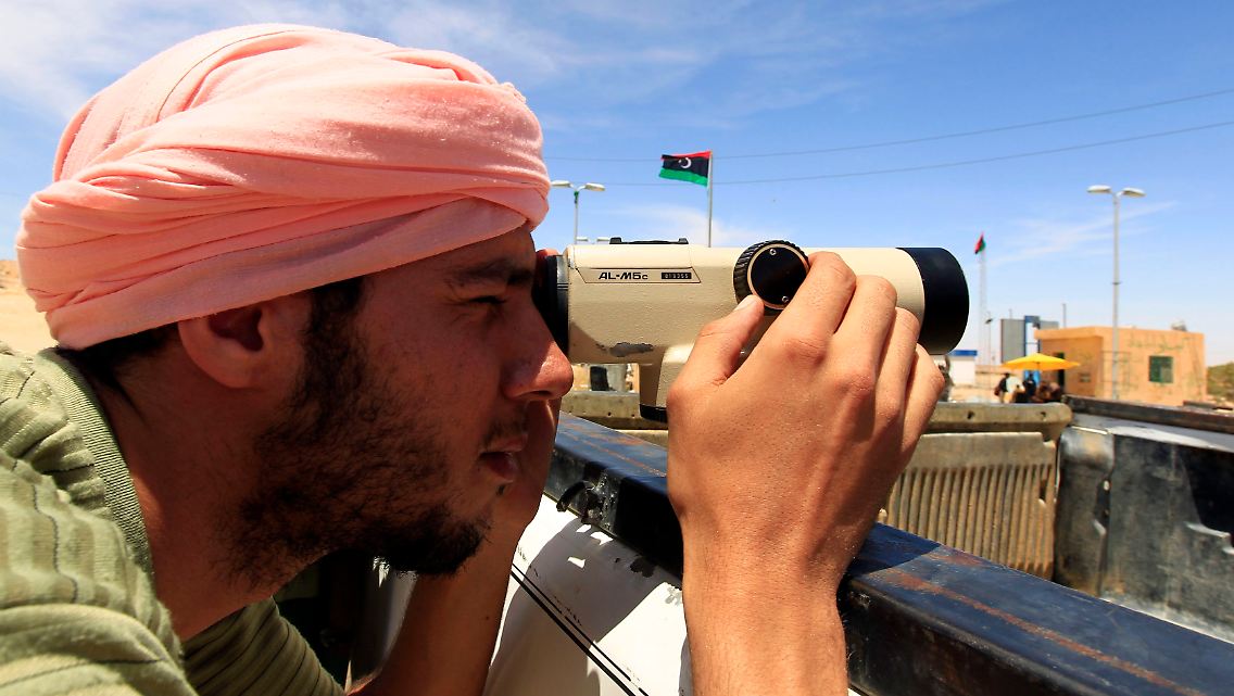 Ein Aufständischer beobachtet bei Wasin die Bombardierung durch die Gaddafi-Truppen.