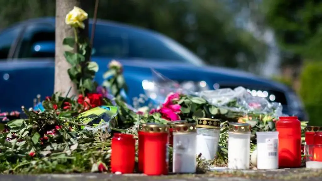 Blumen-und-Kerzen-stehen-an-der-Unfallstelle-an-der-eine-unbeteiligte-Frau-gestorben-ist