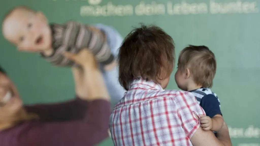 Eine-Frau-steht-mit-einem-Kind-vor-einem-Plakat-mit-der-Aufschrift-Pflegekinder-machen-dein-Leben-bunter