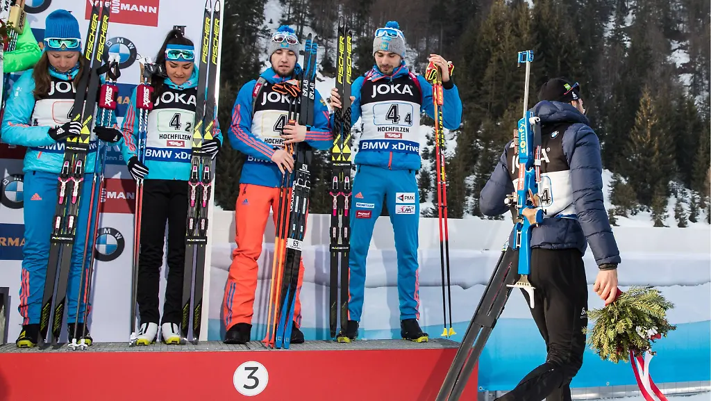 HOCHFILZEN-AUSTRIA-FEBRUARY-9-2017-Bronze-medalists-Olga-Podchufarova-Tatyana-Akimova-Alexander-Loginov-Anton-Shipulin-of-Russia-and-silver-medalist-Martin-Fourcade-of-France-L-R-at-an-award-ceremony-for-the-2-6-km-2-7-5-km-Mixed-Relay-event-at-the-2017-IBU-Biathlon-World-Championships-in-Hochfilzen-Austria