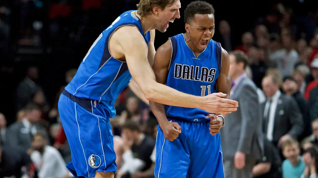 Dallas-Mavericks-guard-Yogi-Ferrell-right-and-forward-Dirk-Nowitzki-react-after-Ferrell-made-a-3-point-basket-against-the-Portland-Trail-Blazers-during-the-second-half-of-an-NBA-basketball-game-in-Portland-Ore-Friday-Feb-3-2017