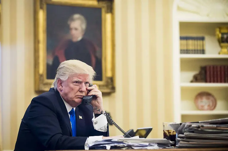 January-28-2017-Washington-District-of-Columbia-United-States-of-America-United-States-President-Donald-Trump-speaks-on-the-phone-with-Prime-Minister-of-Australia-Malcolm-Turnbull-in-the-Oval-Office-on-January-28-2017-in-Washington-DC-The-call-was-one-of-five-calls-with-foreign-leaders-scheduled-for-Saturday