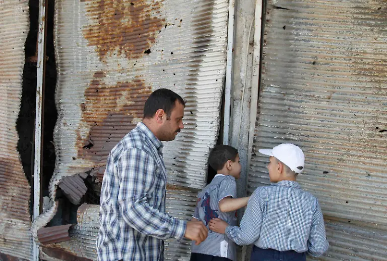 2014-05-09T161741Z-619819801-GM1EA591UGV01-RTRMADP-3-SYRIA-CRISIS-HOMS-JPG6160247559446352686