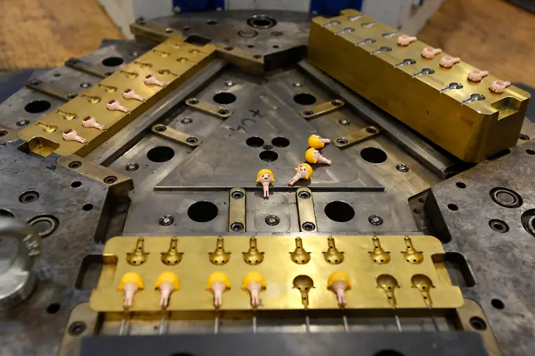 Heads-of-Playmobil-figures-lie-on-their-injection-mould