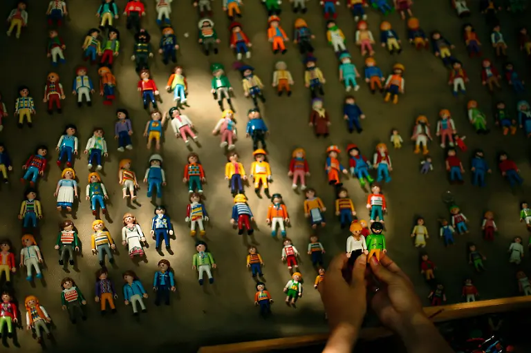 A-woman-browses-Playmobil-toys-at-Feira-da-Ladra-Thieves-Fair-in-Lisbon-August-3-2013