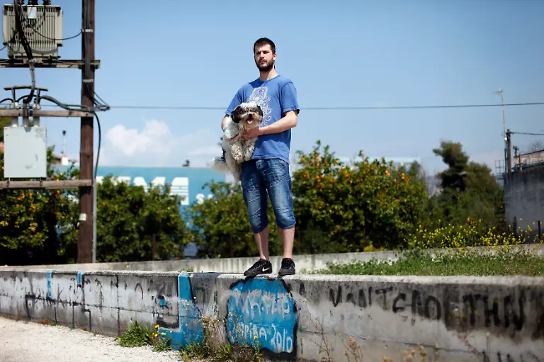Thanos-Kechagias-22-a-student-poses-for-a-picture-with-his-dog-Vagos-outside-his-flat-in-Patra-March-26-2012-When-asked-how-he-had-been-affected-by-the-economic-crisis-Kechagias-replied-My-family-have-had-to-move-to-England-to-find-work-after-our-restaurant-failed-but-I-ve-stayed-behind-to-go-to-university-Picture-taken-March-26-2012