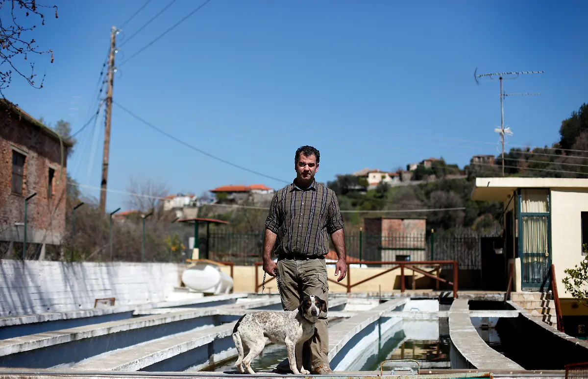 Giannis-Gerontidis-37-a-fish-farmer-poses-for-a-picture-at-his-fish-farm-in-the-village-of-Kastoreio-at-the-Peloponnese-area-of-Greece-March-20-2012-When-asked-how-he-had-been-affected-by-the-economic-crisis-Gerontidis-replied-I-haven-t-been-affected-on-a-big-scale-as-our-clients-are-wealthy-and-don-t-have-any-problem-buying-our-products-Picture-taken-March-20-2012