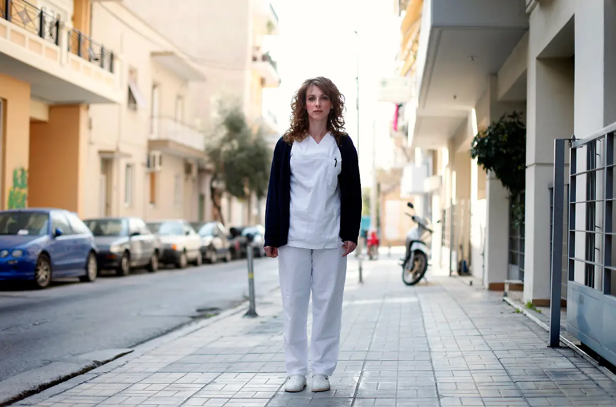 Pauline-Delli-32-a-psychiatric-nurse-poses-in-the-street-outside-her-place-of-work-in-Athens-March-27-2012-When-asked-how-she-had-been-affected-by-the-economic-crisis-Delli-replied-I-am-just-living-day-to-day-and-not-thinking-about-the-future-Picture-taken-March-27-2012