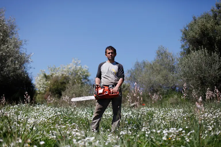 Dimitris-Stamatakos-36-an-olive-farmer-stands-among-olive-trees-on-land-he-is-renting-near-his-home-in-the-village-of-Krokeae-at-the-Peloponnese-area-of-Greece-March-18-2012-When-asked-how-he-had-been-affected-by-the-economic-crisis-Stamatakos-replied-I-row-with-my-wife-a-lot-about-money-She-thinks-I-should-be-doing-more-What-more-can-I-do-I-m-just-getting-by