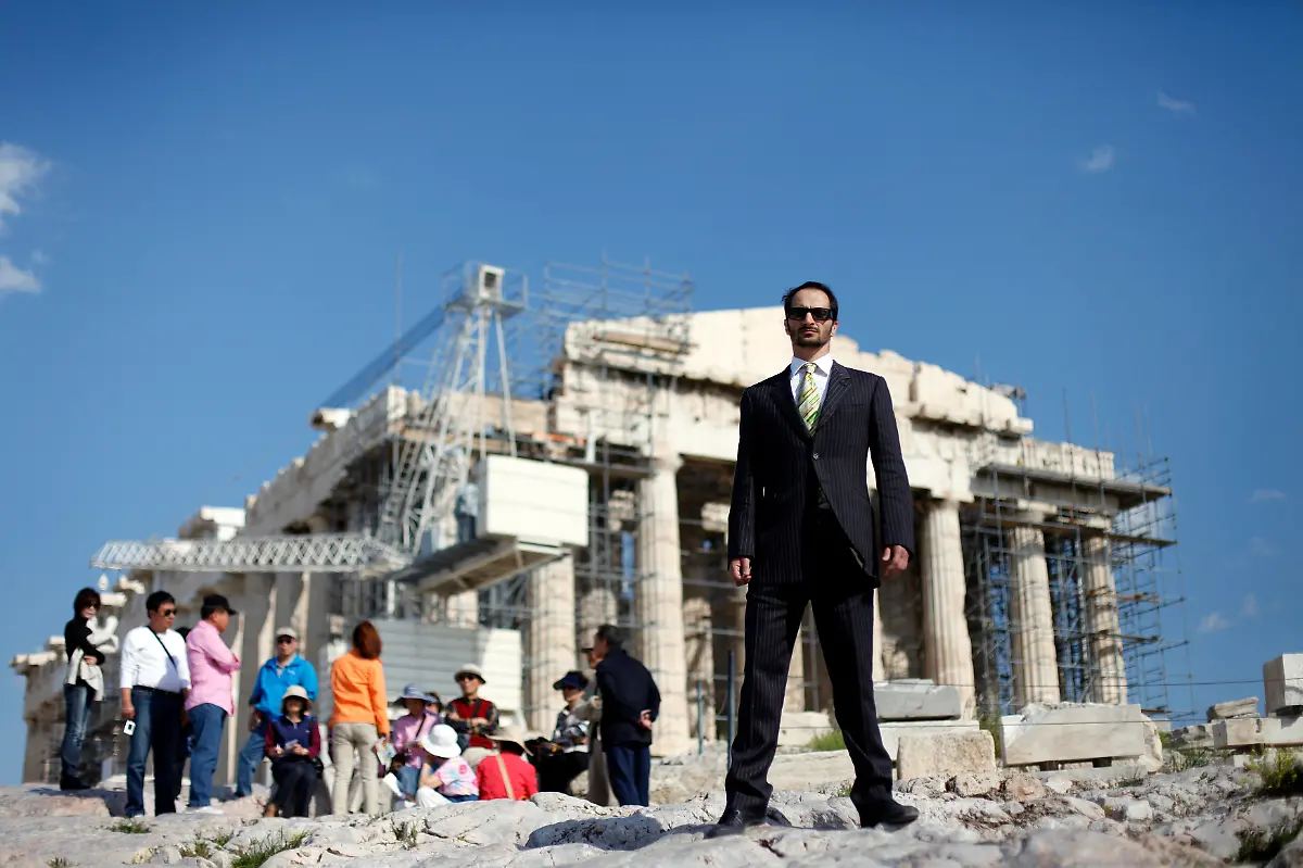 Phoevos-Doudonis-37-an-actor-singer-poses-for-a-picture-in-front-of-the-Acropolis-in-Athens-March-28-2012-When-asked-how-he-had-been-affected-by-the-economic-crisis-Duodonis-replied-up-to-April-2011-I-was-making-a-good-living-as-an-actor-and-singer-but-I-have-been-finding-it-difficult-since-then-to-find-any-work-Fees-have-been-cut-by-70-80-and-some-theatres-don-t-pay-at-all-Picture-taken-March-28-2012