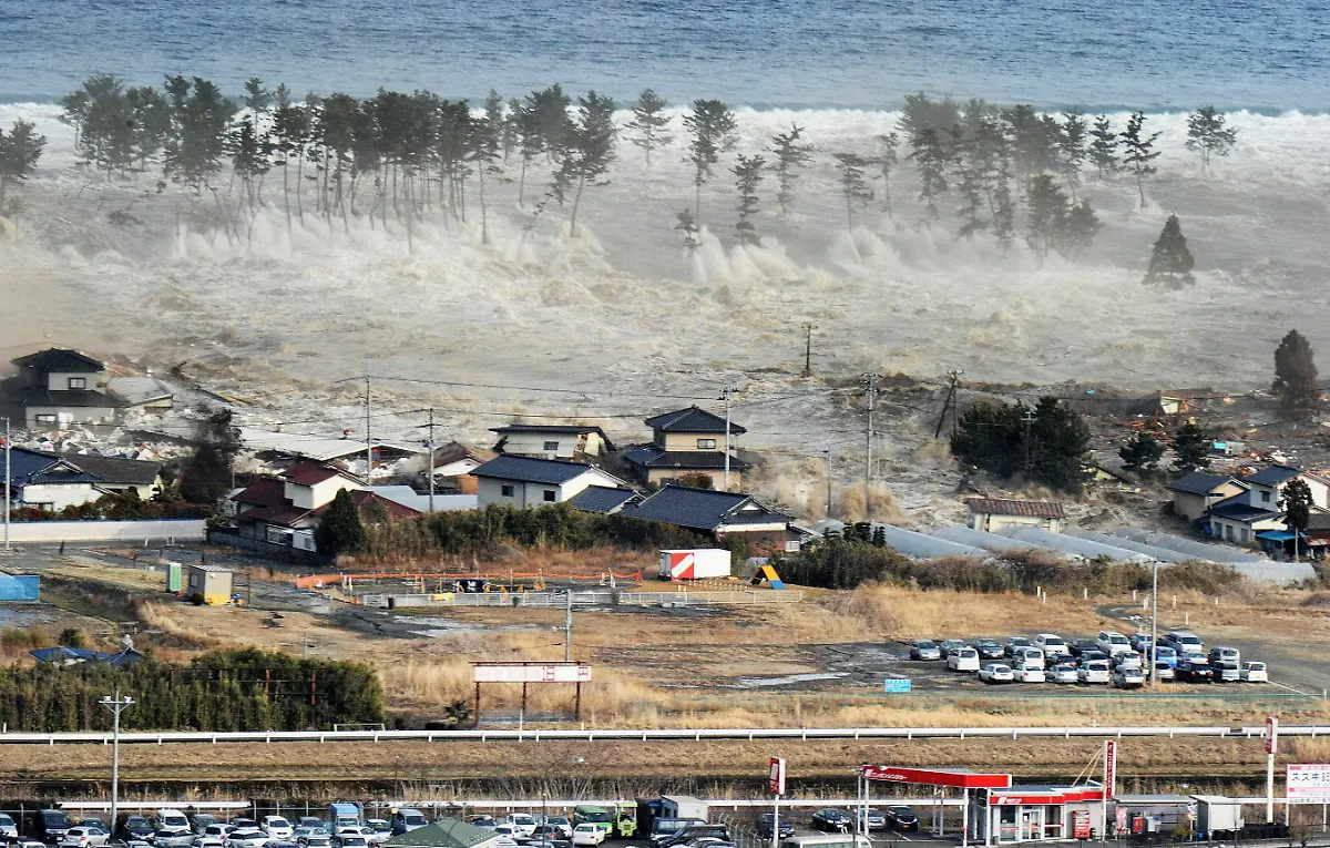 A-massive-tsunami-engulfs-a-residential-area-after-a-powerful-earthquake-in-Natori-Miyagi-Prefecture-northeastern-Japan-on-March-11-2011