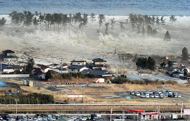 A-massive-tsunami-engulfs-a-residential-area-after-a-powerful-earthquake-in-Natori-Miyagi-Prefecture-northeastern-Japan-on-March-11-2011