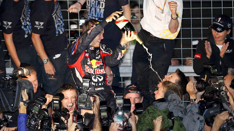 Geduscht wird zum Schluss: Sebastian Vettel mit seinem Team.