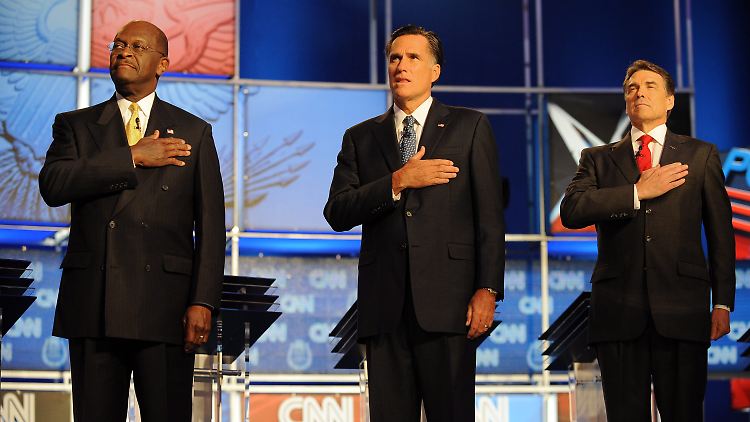 Die Kandidaten Herman Cain (l.), Mitt Romney (M.) und Rick Perry vor einer CNN-Debatte in Las Vegas.